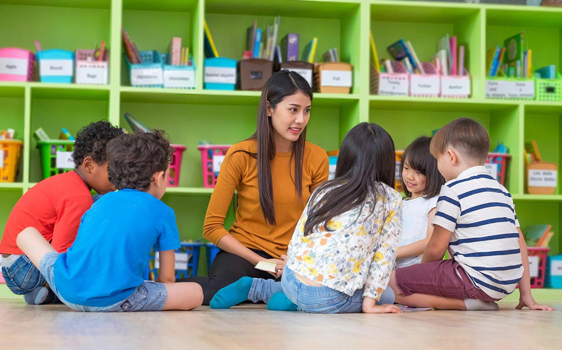 Teacher reading to attentive children.